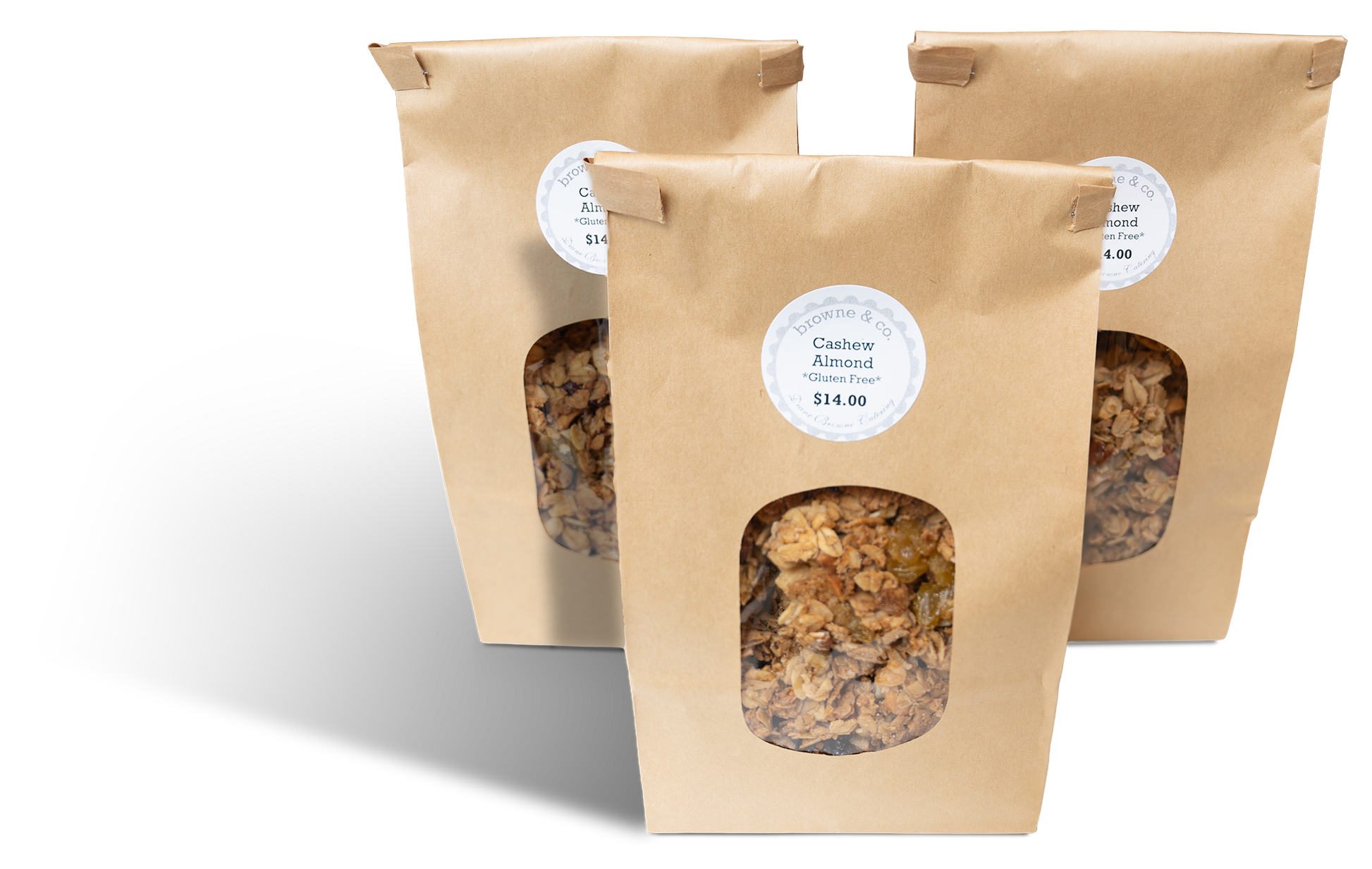 Three bags of cashew almond granola from browne & co. Brown bag has a window to show the granola inside. Two bags are behind and to the left and right of the front bag in the middle.